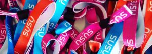 A pile of Stand Up Speak Up wristbands