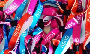 A pile of Stand Up Speak Up wristbands