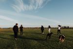 a group of teenagers walking across a field