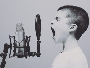 Boy speaking into a microphone