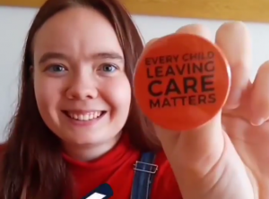 Zara holding a badge